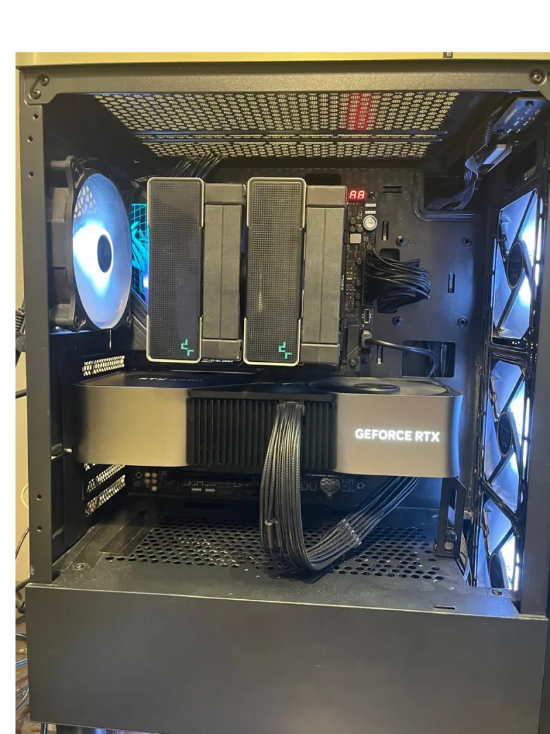 Open PC case: the RTX 4080 Founders Edition mounted horizontally above the power supply shroud, a twin-tower air cooler above it, and case fans front and rear.